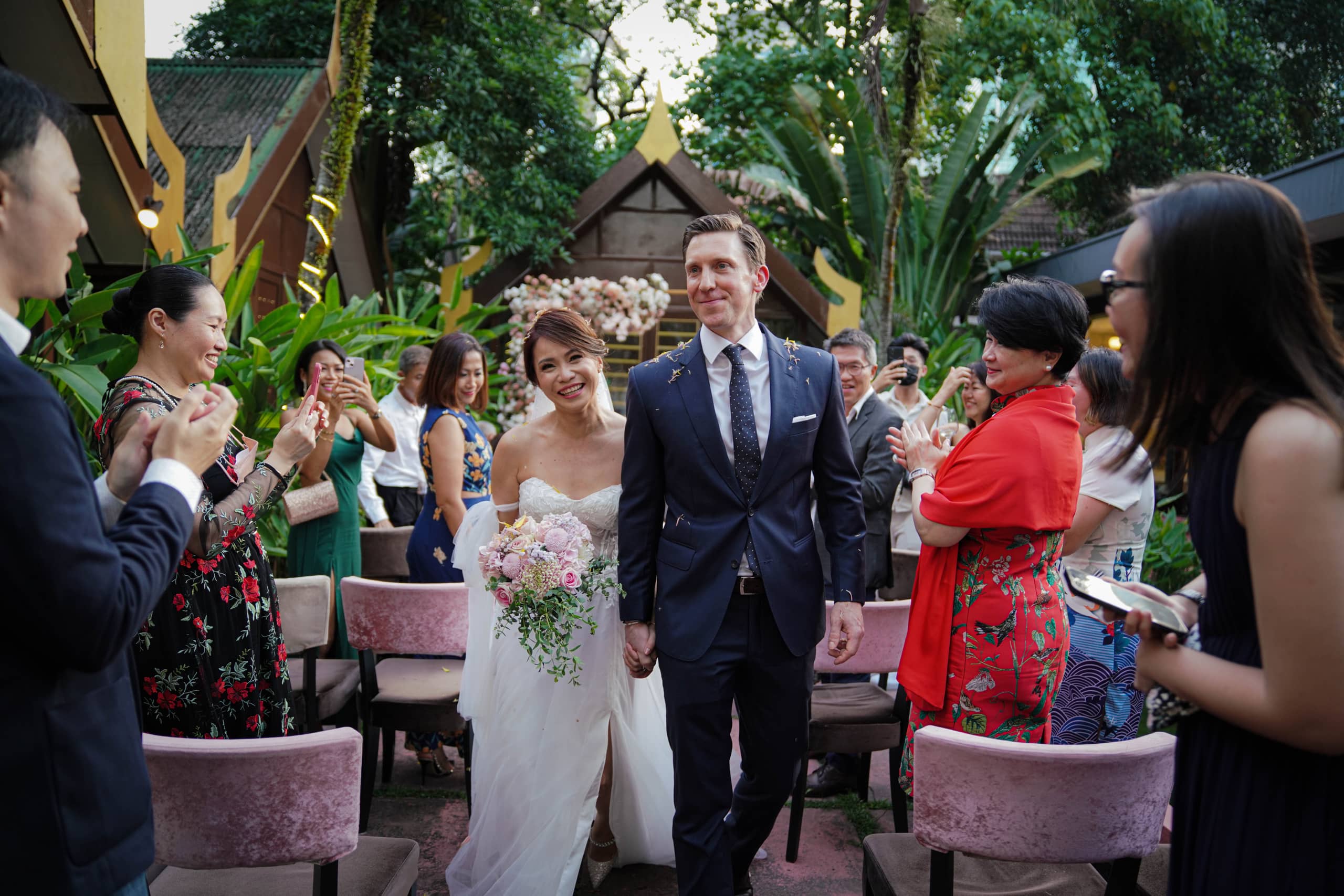 Wedding couple walking through a celebration